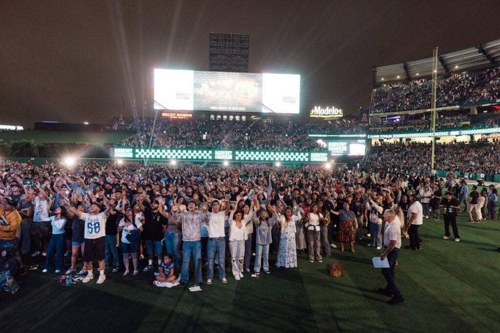 people gather on the field at Angel Stadium to make a profession of faith at the 2025 harvest crusade